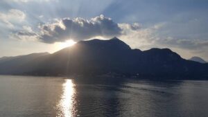 Sun setting over mountain of Lake Como Italy walking vacation