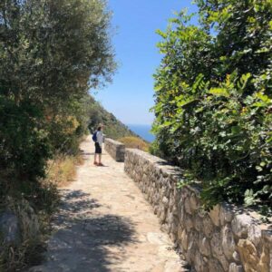 Woman on stone path Italy walking vacation