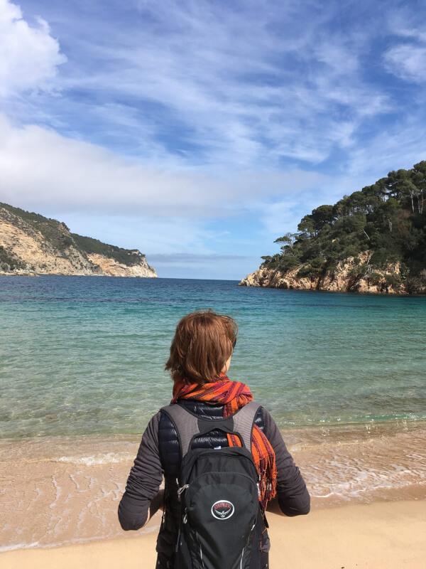 woman looking at water on walking vacation in Spain